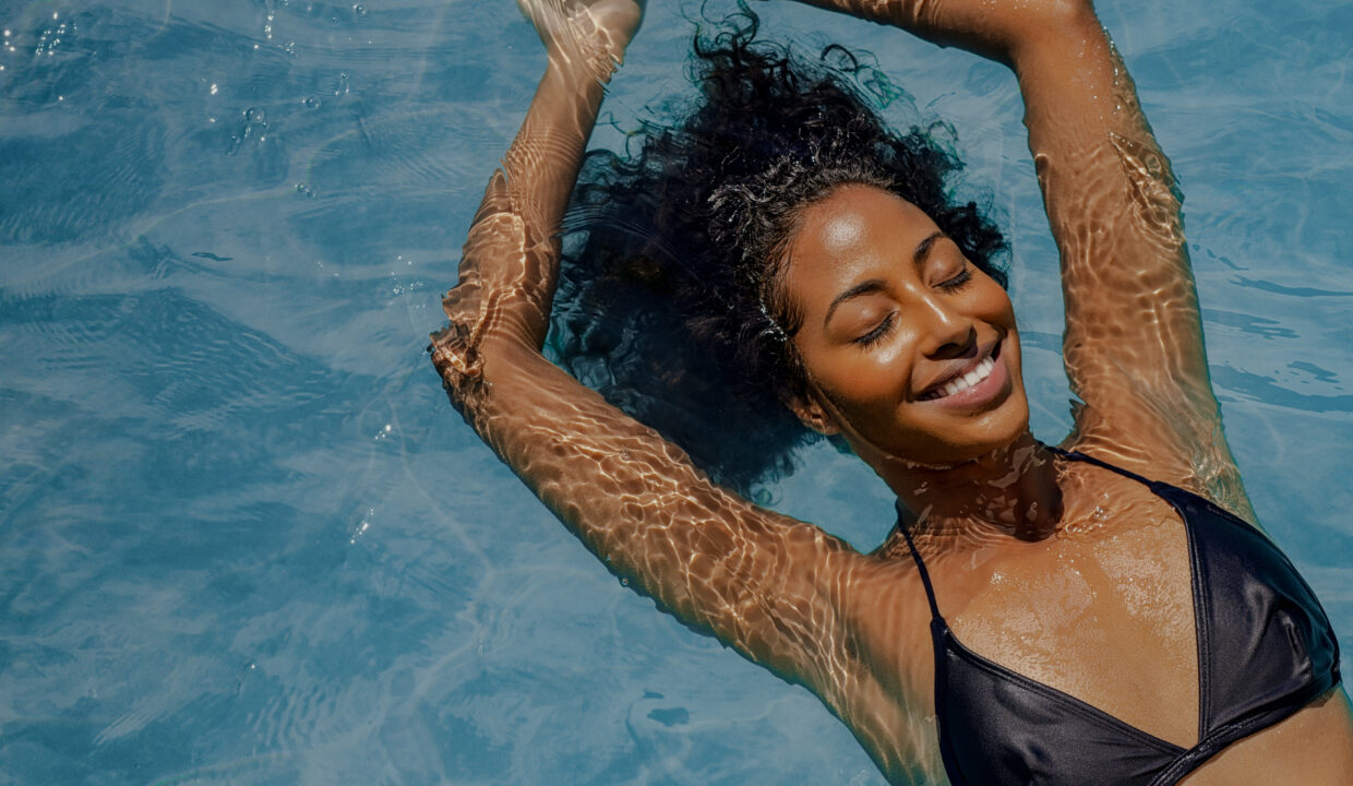 High,Angle,View,Of,Black,Woman,Relaxing,In,The,Water