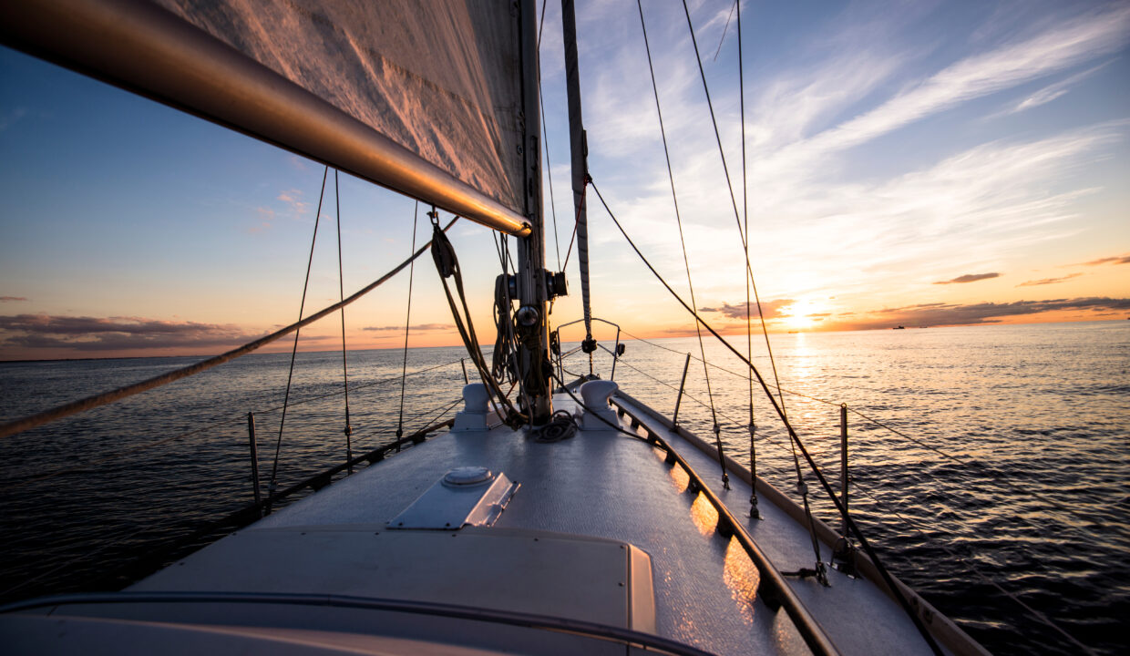 White,Sloop,Rigged,Yacht,Sailing,At,Sunset.a,View,Of,The